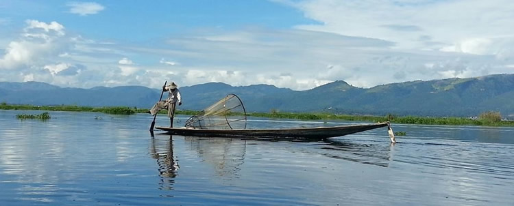 Fisherman rowing with a leg
